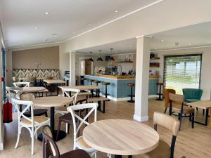 a restaurant with tables and chairs and a counter at Sunrise in Brixham