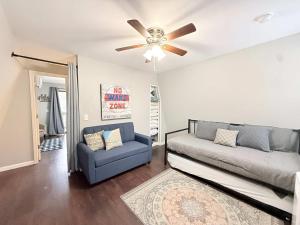 a living room with a couch and a ceiling fan at A Frame Escape Lake Access in Rocky Mount