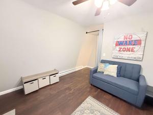 a living room with a blue couch and a no wake zone sign at A Frame Escape Lake Access in Rocky Mount +12 photos
