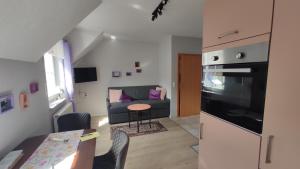 a living room with a couch and a table at Ferienhaus Moselpanorama in Ellenz-Poltersdorf