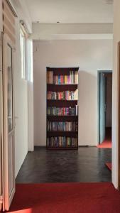 a room with a book shelf filled with books at Mellow Breeze - Nuwara Eliya in Nuwara Eliya +20 photos