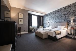 Postel nebo postele na pokoji v ubytování Hotel Carlton