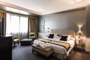 Postel nebo postele na pokoji v ubytování Hotel Carlton