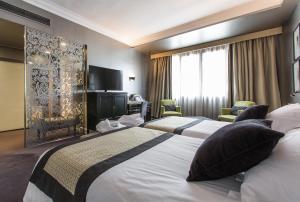 Postel nebo postele na pokoji v ubytování Hotel Carlton
