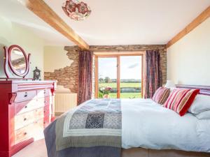 a bedroom with a bed and a large window at 4 Bed in Gillingham oc-80670 in West Stour