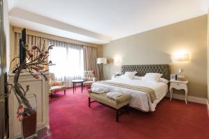 Postel nebo postele na pokoji v ubytování Hotel Carlton