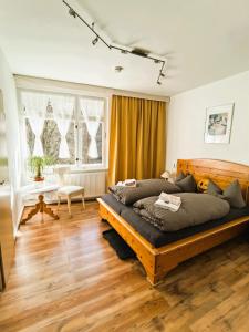 a bedroom with a large wooden bed in a room at Pension im Tal der Stille - Thale OT Treseburg in Thale