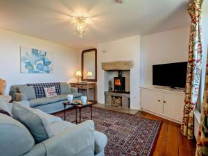 a living room with a couch and a tv at 4 Bed in Swanage oc-76659 in Langton Matravers