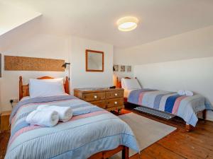 a bedroom with two beds with towels on them at 4 Bed in Swanage oc-76659 in Langton Matravers
