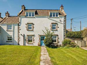 a large white house with a green yard at 4 Bed in Swanage oc-76659 in Langton Matravers