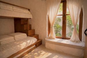 a bedroom with two bunk beds and a window at AnB Garden in Ða Gia