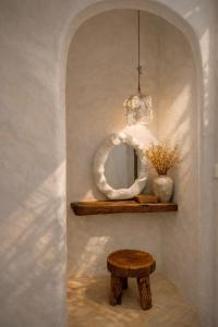 a room with a table and a stool and a chandelier at AnB Garden in Ða Gia +37 photos