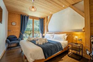 a bedroom with a large bed in a room with wooden walls at Hameau des clos Virolet in Les Gets