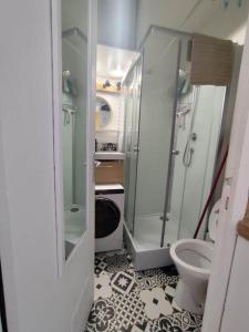 a small bathroom with a shower and a toilet at Le 4 Saisons in Ustou