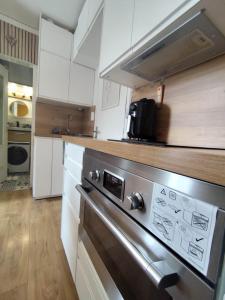 a kitchen with a stainless steel stove top oven at Le 4 Saisons in Ustou +8 photos