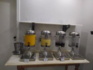 a counter with four blenders on a table at Diamond Hotel in Rio de Janeiro +55 photos