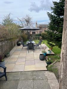 a patio with a table and chairs and an umbrella at Seaview in Montrose