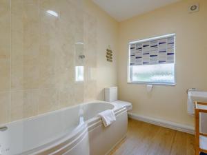 a white bathroom with a tub and a sink at 2 Bed in Shanklin oc-78239 in Shanklin +13 photos