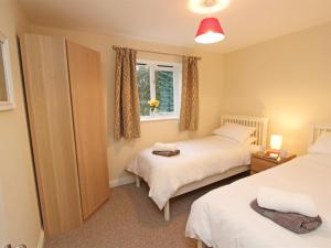 a bedroom with two beds and a window at 3 Bed in Rowlands Gill oc-cn209 in Rowlands Gill
