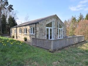 a stone house with a porch in a field at 3 Bed in Rowlands Gill oc-cn209 in Rowlands Gill