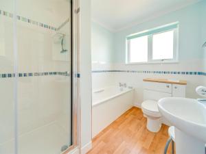 a bathroom with a shower and a toilet and a sink at 2 Bed in Brighstone oc-ic132 in Brighstone +3 photos