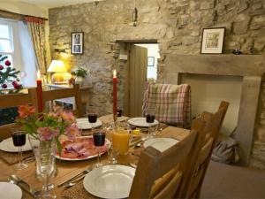 a dining room with a table with food and candles at 4 Bed in Kettlewell oc-g0041 in Starbotton