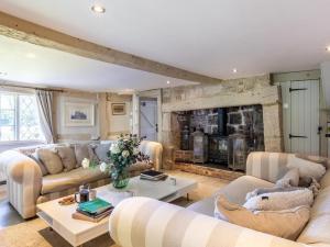 a living room with two couches and a fireplace at 6 Bed in Lymington oc-56765 in Boldre