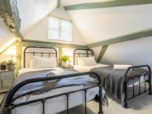 two beds in a room with a attic at 6 Bed in Lymington oc-56765 in Boldre +28 photos