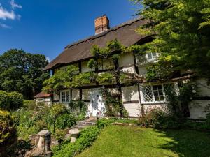 an old house with ivy on the side of it at 6 Bed in Lymington oc-56765 in Boldre