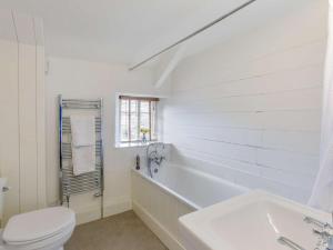 a white bathroom with a tub and a toilet at 2 Bed in Dulverton oc-47152 in East Anstey +14 photos