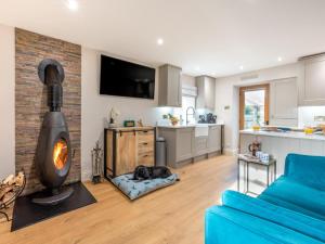 a living room with a blue couch and a fireplace at 1 Bed in Richmond oc-88589 in Easby