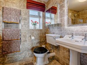 a bathroom with a toilet and a sink and a mirror at 1 Bed in Sherborne oc-87292 in Lillington +14 photos