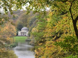 a garden with a building in the middle of a river at 1 Bed in Sherborne oc-87292 in Lillington