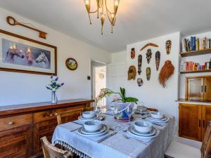 a dining room with a table with dishes on it at 3 Bed in Wareham oc-78831 in Corfe Castle