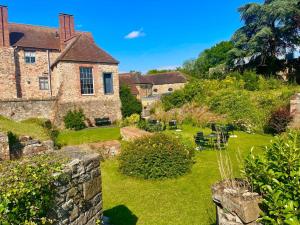an old stone house with a green yard at Castle Hotel in Taunton