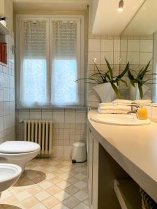 a bathroom with a sink and a toilet at B&B La Littorina - Parcheggio Privato in Foligno +2 photos