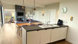 a kitchen with a sink and a counter top at Jog Lodge 4 By Together Travel - 3 Bed in John O Groats +14 photos
