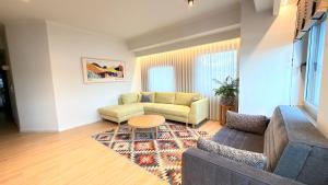 a living room with a couch and a table at Kyveli Lake Suite in Kastoria