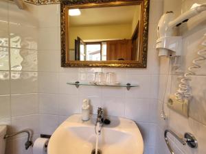 a bathroom with a sink and a mirror at Casa Pelayin in Cue +45 photos