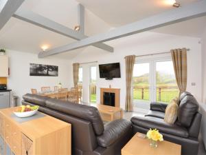 a living room with a couch and a table at 3 Bed in Bridgwater oc-56284 in Greinton