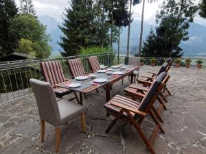 a wooden table and chairs with plates on it at Apartment Jacob by Interhome in Dölsach