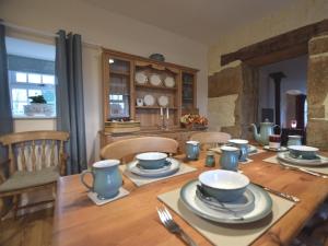 a wooden table with plates and bowls on it at 1 Bed in Newcastle Upon Tyne oc-49414 in Rochester