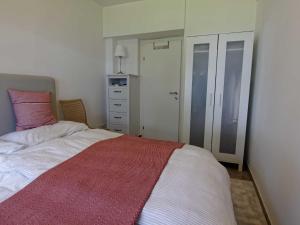 a bedroom with a bed with a red and white blanket at Apartment Jacob by Interhome in Dölsach