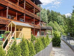 a house with a fence and trees in front of it at Apartment Jacob by Interhome in Dölsach