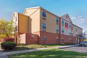 a large building with a car parked in front of it at Studio 6 Corporate Extended Stay Rochester Henrietta NY in Ridgeland