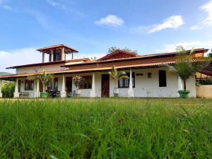 a house with a green field in front of it at Flourish holiday resort in Kataragama