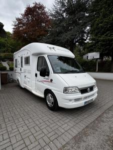 a white camper van parked in a parking lot at Rover Rentals in Inverness