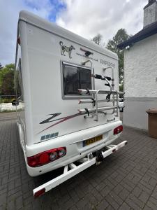 a white trailer with a dog on the back of it at Rover Rentals in Inverness
