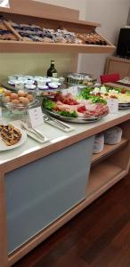 a buffet with many plates of food on it at Best Western Hotel San Marco in Siena