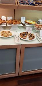 a counter with many plates of food on it at Best Western Hotel San Marco in Siena
